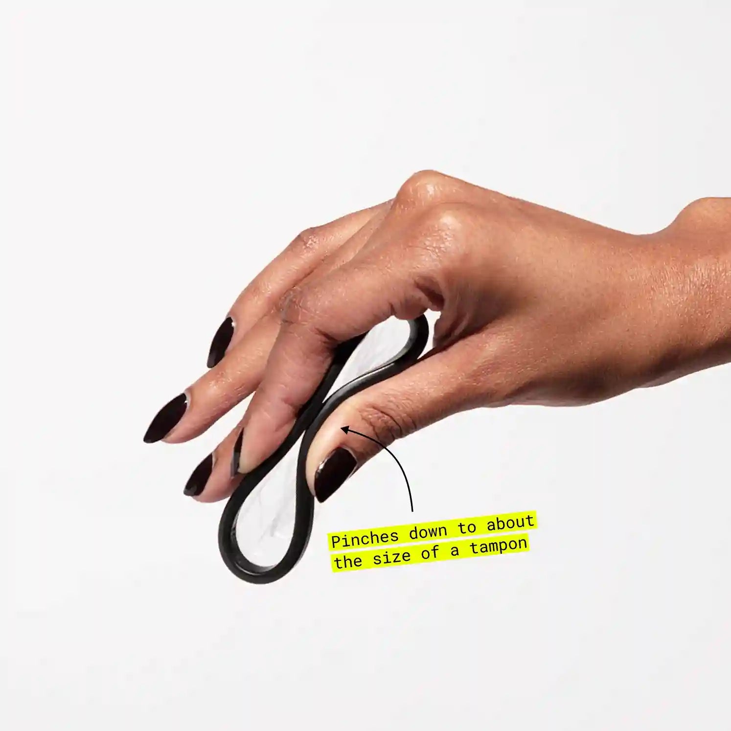 Hand holding folded menstrual disc next to text indicating comparable tampon size