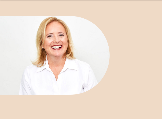 Smiling woman in a white shirt against a neutral background