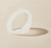 A close up image of Flex Reusable Menstrual Disc showing that it is transluscent white