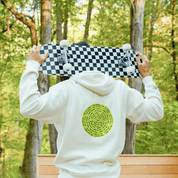 Person holding checkered skateboard behind head while wearing hoodie with circular text design