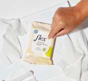 A person opening a pack of Flex biodegradable wipes