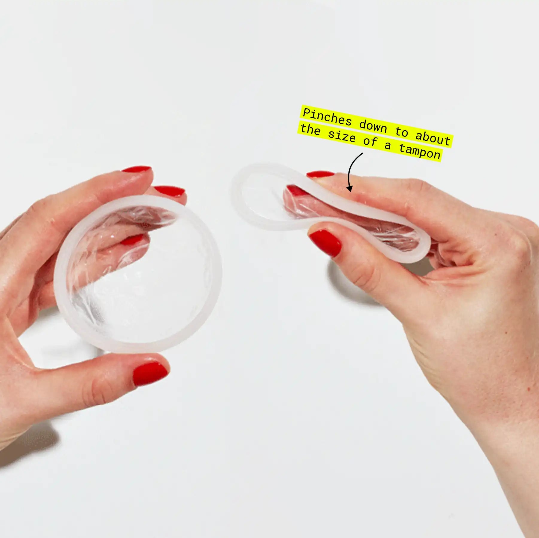 Hands demonstrating how a menstrual disc or cup pinches down to about the size of a tampon for insertion