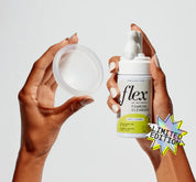 A person holding a flex reusable menstrual disc and a foaming cleanser neroli and rosemary