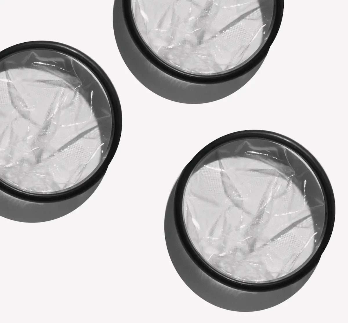 Three Flex Reusable Menstrual discs on a white background