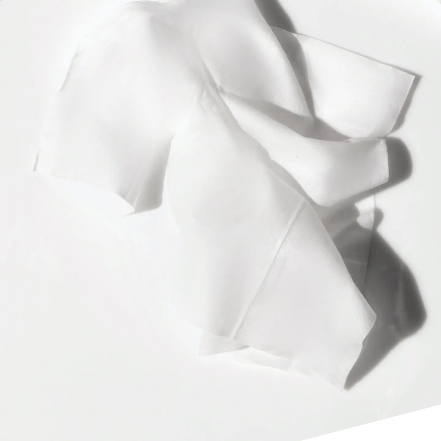 Stack of unfolded menstrual wipes on a flat surface